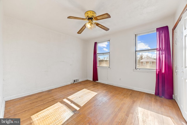 spare room featuring light hardwood / wood-style floors and ceiling fan