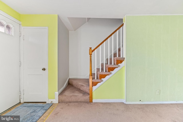 view of carpeted foyer entrance