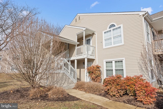 view of side of home featuring a balcony