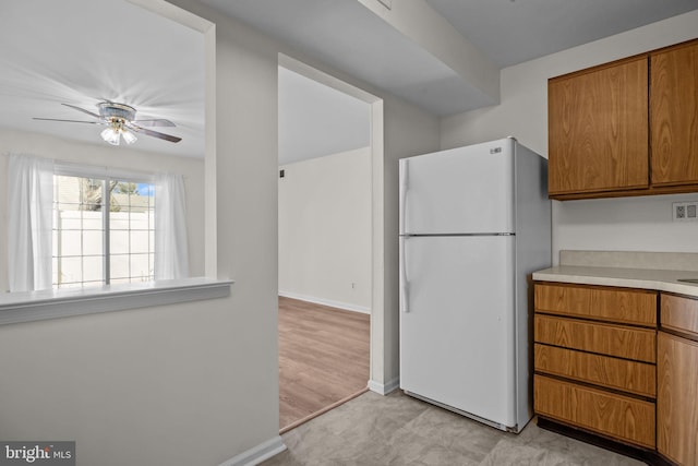 kitchen with white fridge and ceiling fan