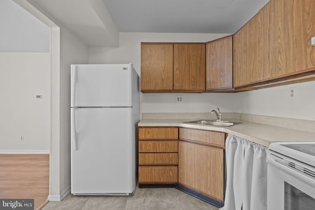 kitchen with white fridge and sink