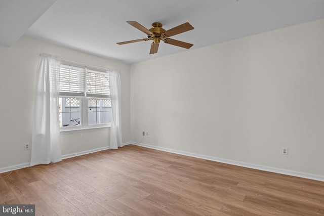 spare room featuring ceiling fan and light hardwood / wood-style floors