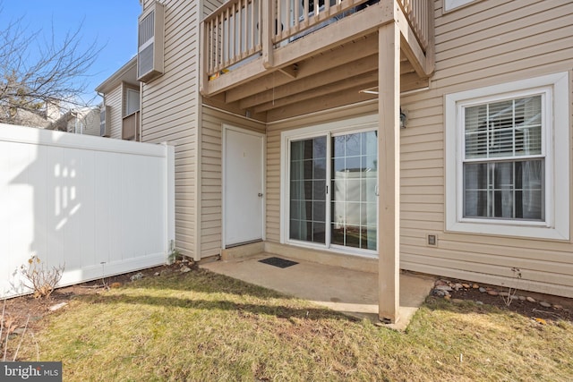 entrance to property with a patio and a lawn