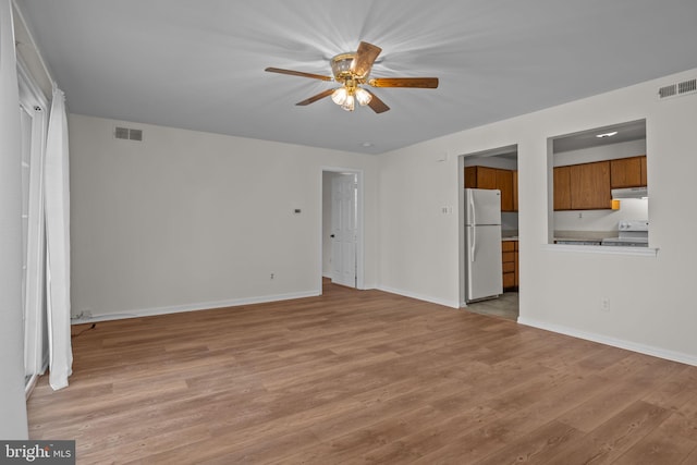 unfurnished living room featuring ceiling fan and light wood-type flooring