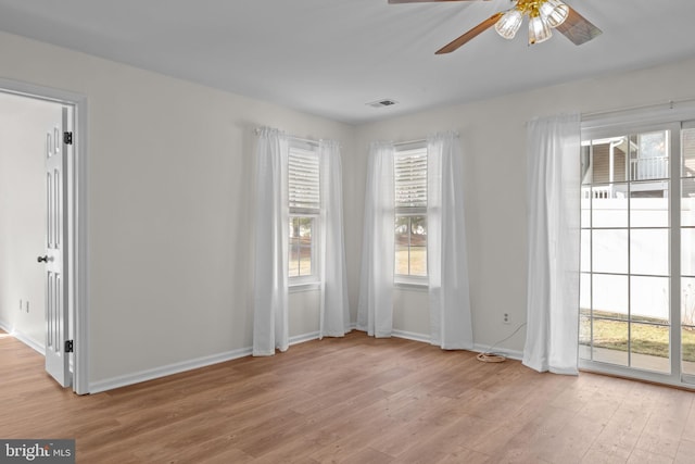 unfurnished room with ceiling fan and light wood-type flooring