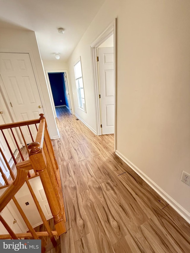 hall with light hardwood / wood-style flooring