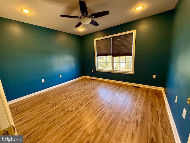 unfurnished room featuring ceiling fan and light hardwood / wood-style flooring