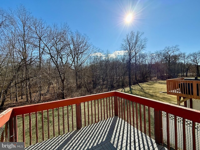 wooden deck with a lawn