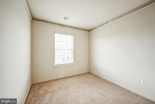 carpeted spare room featuring visible vents and baseboards