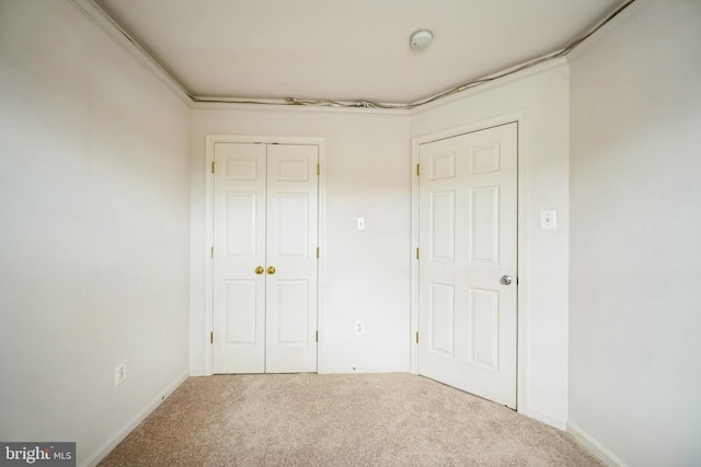 unfurnished bedroom featuring carpet floors, a closet, and baseboards