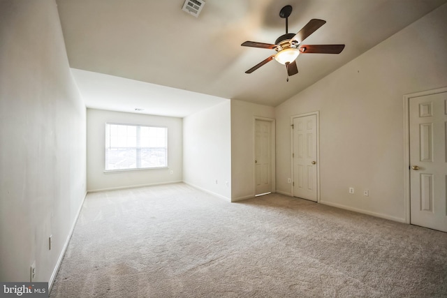 unfurnished room featuring vaulted ceiling, carpet floors, visible vents, and baseboards