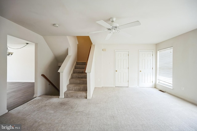 interior space featuring a ceiling fan, carpet flooring, and visible vents