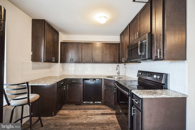 kitchen featuring dark brown cabinetry, electric range, a sink, black dishwasher, and stainless steel microwave