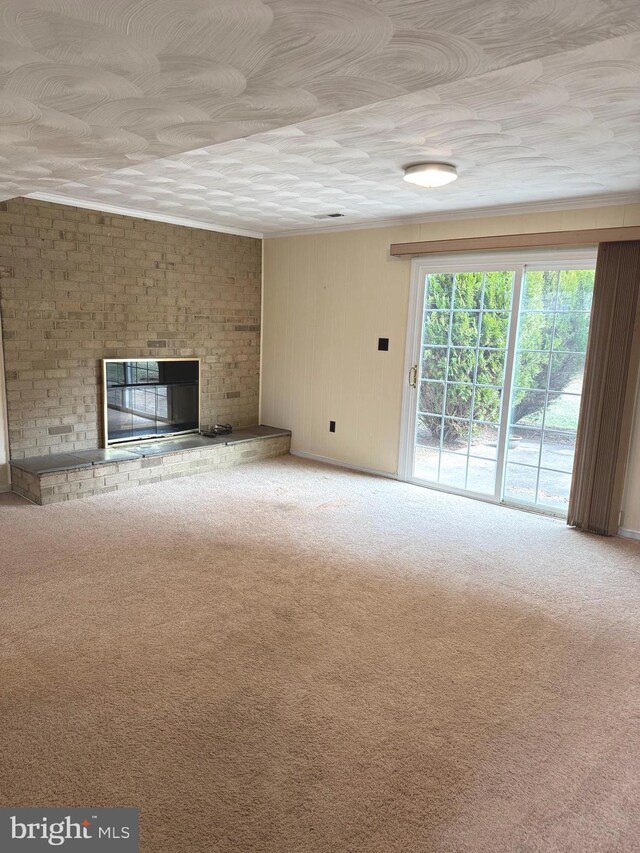 unfurnished living room featuring carpet floors and a fireplace