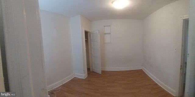 corridor featuring wood-type flooring