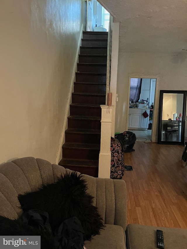 stairway featuring hardwood / wood-style floors