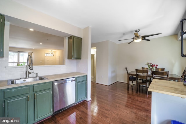 kitchen with dark wood-type flooring, a sink, stainless steel dishwasher, light countertops, and decorative backsplash