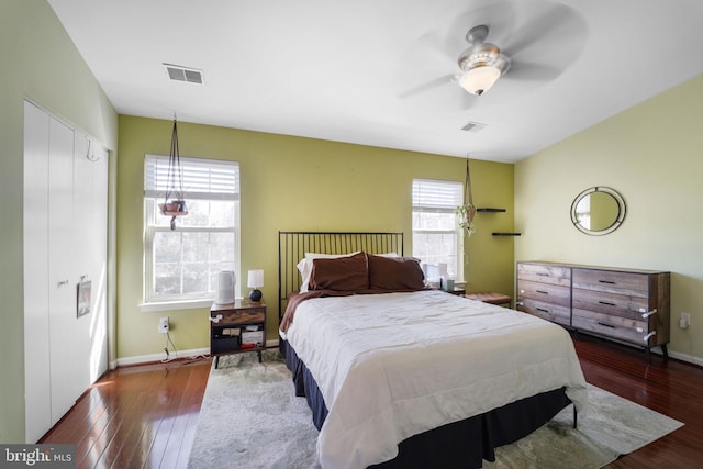 bedroom featuring visible vents, baseboards, and hardwood / wood-style floors