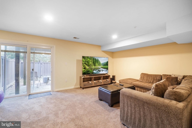 living room with visible vents, baseboards, and light colored carpet