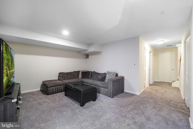 carpeted living area featuring visible vents and baseboards