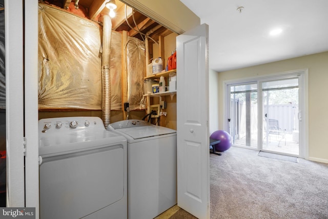 laundry room with separate washer and dryer, carpet flooring, and laundry area