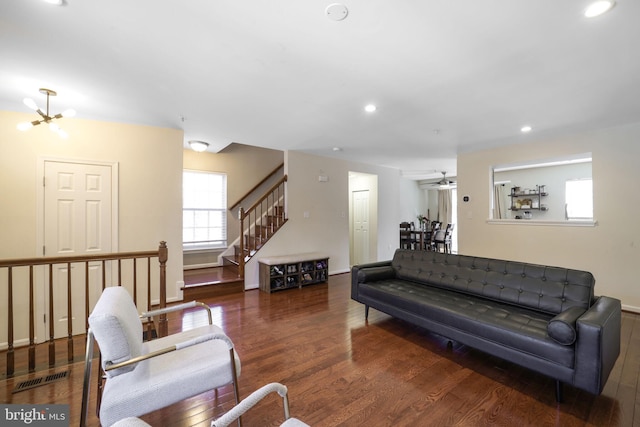 living area featuring recessed lighting, visible vents, wood finished floors, and stairway