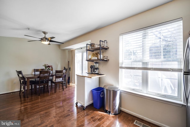 dining space featuring dark wood finished floors, visible vents, ceiling fan, and baseboards