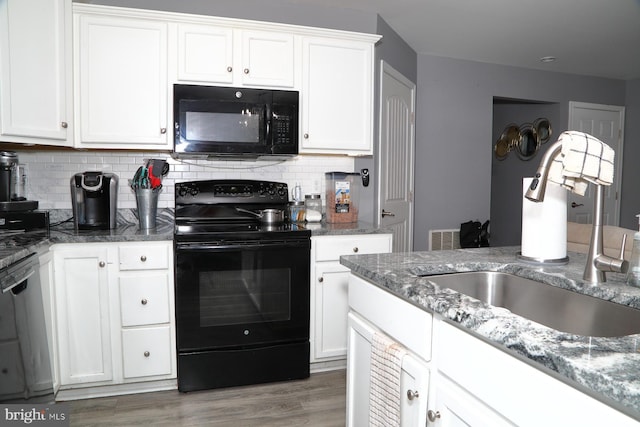 kitchen featuring sink, white cabinetry, wood-type flooring, decorative backsplash, and black appliances