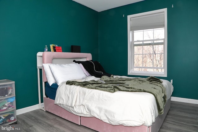 bedroom with hardwood / wood-style flooring