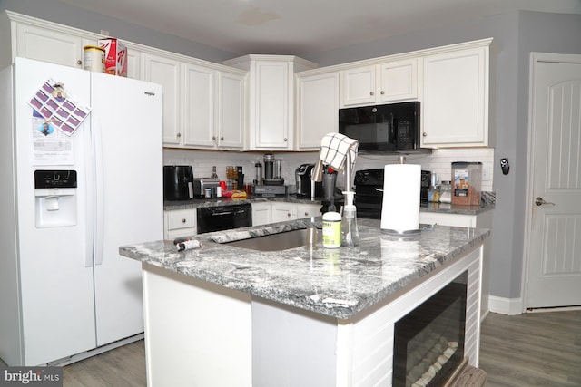 kitchen with white cabinetry, a kitchen island, and black appliances