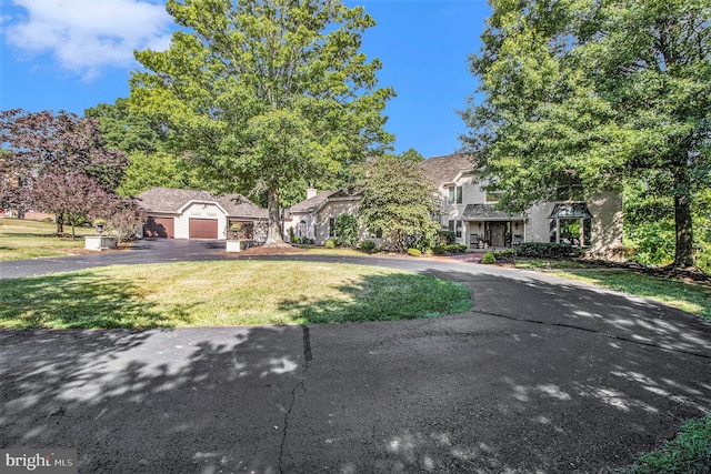 view of front of home featuring a garage and a front lawn