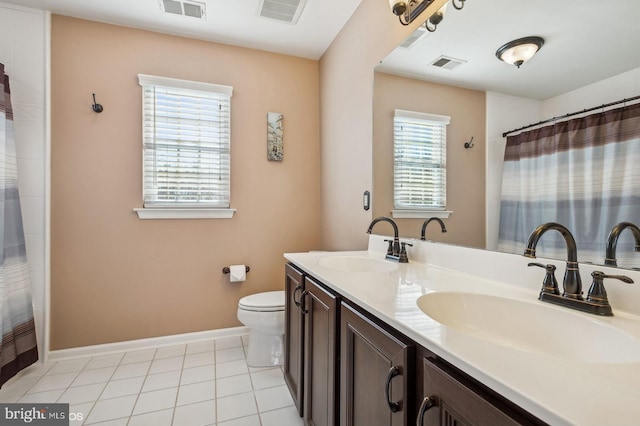 bathroom with vanity, tile patterned floors, and toilet