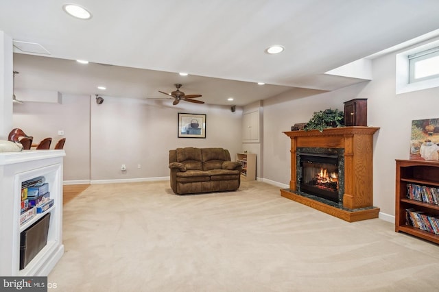 living area featuring ceiling fan and light carpet