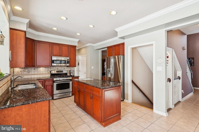 kitchen with dark stone countertops, sink, a center island, and appliances with stainless steel finishes