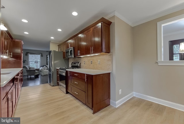 kitchen with tasteful backsplash, ornamental molding, stainless steel appliances, and light wood-type flooring