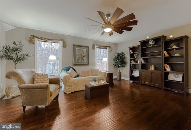 sitting room featuring dark wood-type flooring and ceiling fan