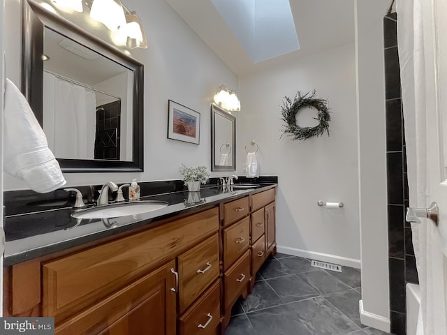 bathroom featuring vanity, tile patterned flooring, and a shower with shower curtain