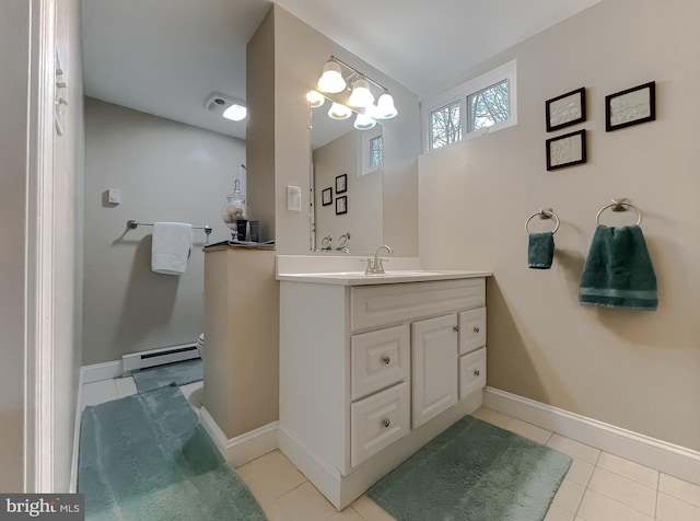 bathroom featuring baseboard heating, tile patterned floors, vanity, and an inviting chandelier