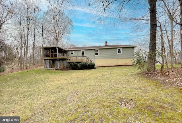 back of house with a lawn, a sunroom, and a deck