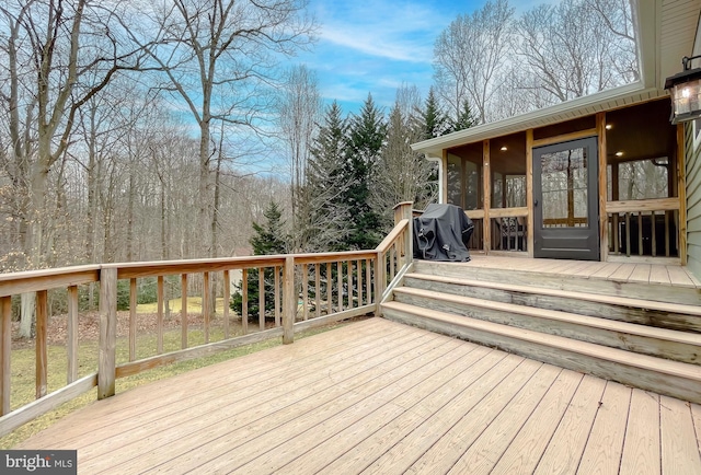 deck featuring grilling area and a sunroom