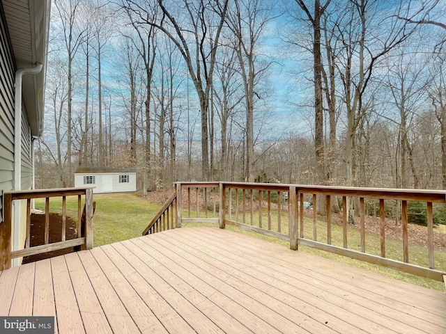 deck featuring a yard and an outdoor structure