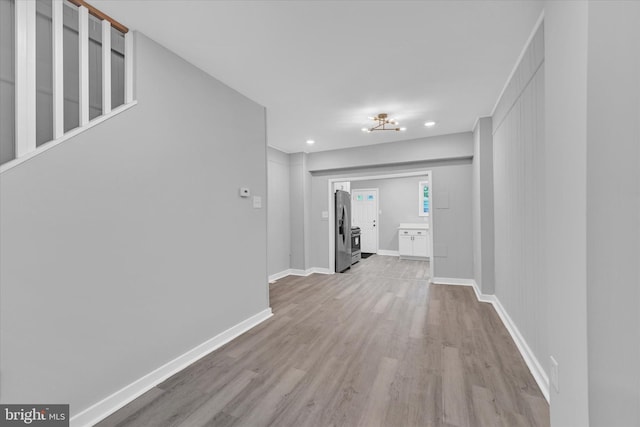 hallway with light hardwood / wood-style flooring