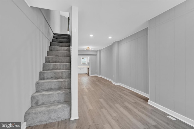 stairway featuring hardwood / wood-style flooring