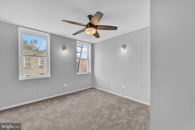 carpeted empty room featuring ceiling fan