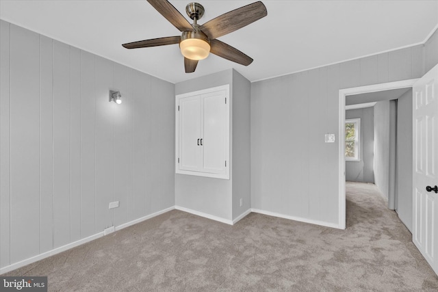 spare room with light carpet and ceiling fan