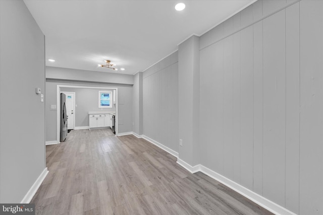 hallway with light hardwood / wood-style floors