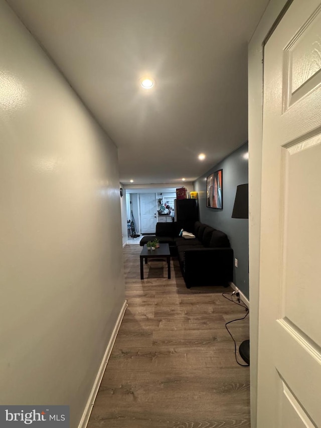 hallway with hardwood / wood-style floors