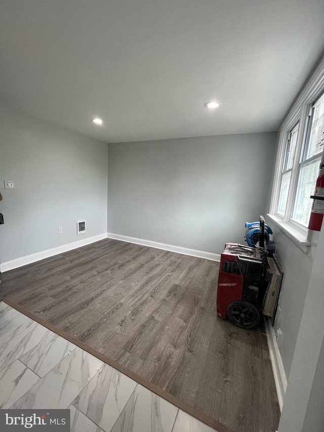 unfurnished room featuring hardwood / wood-style flooring