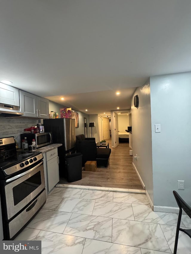 kitchen featuring gray cabinetry, tasteful backsplash, and stainless steel appliances