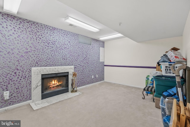 recreation room with light carpet and a high end fireplace